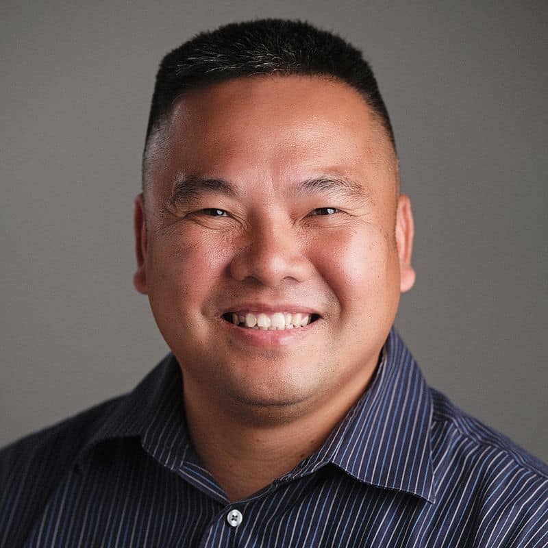 a man smiling at the camera