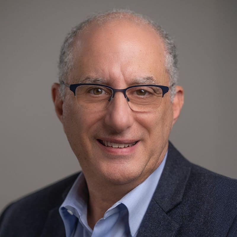 a man wearing glasses and a suit
