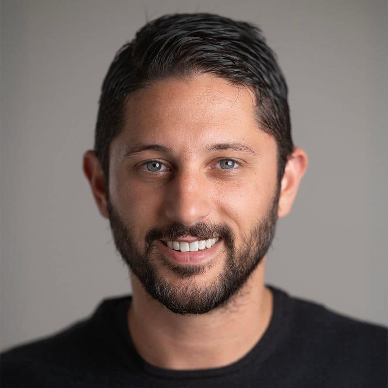 a man smiling at the camera