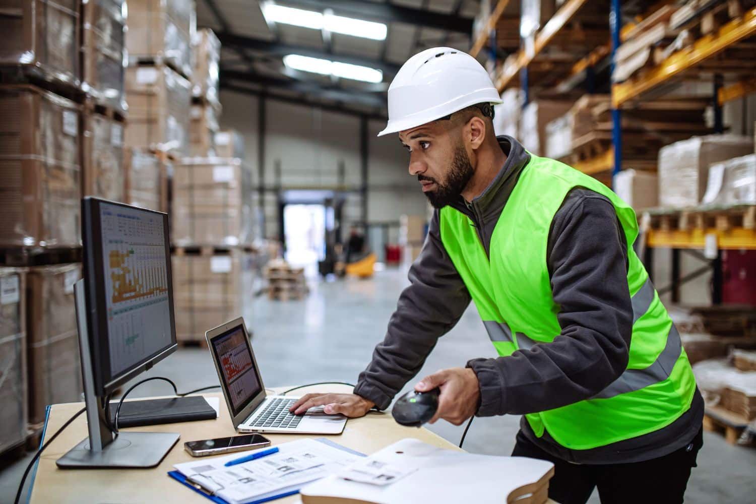 a man in a hard hat using a computer