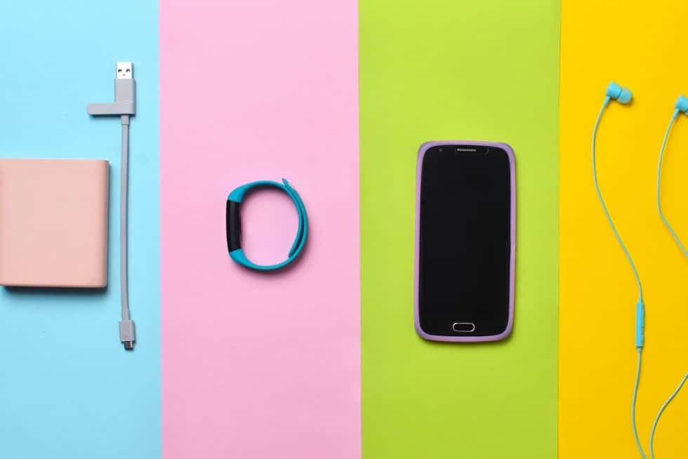 a phone and a charger on a colorful background