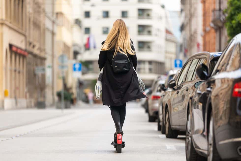 a woman riding a scooter on a street