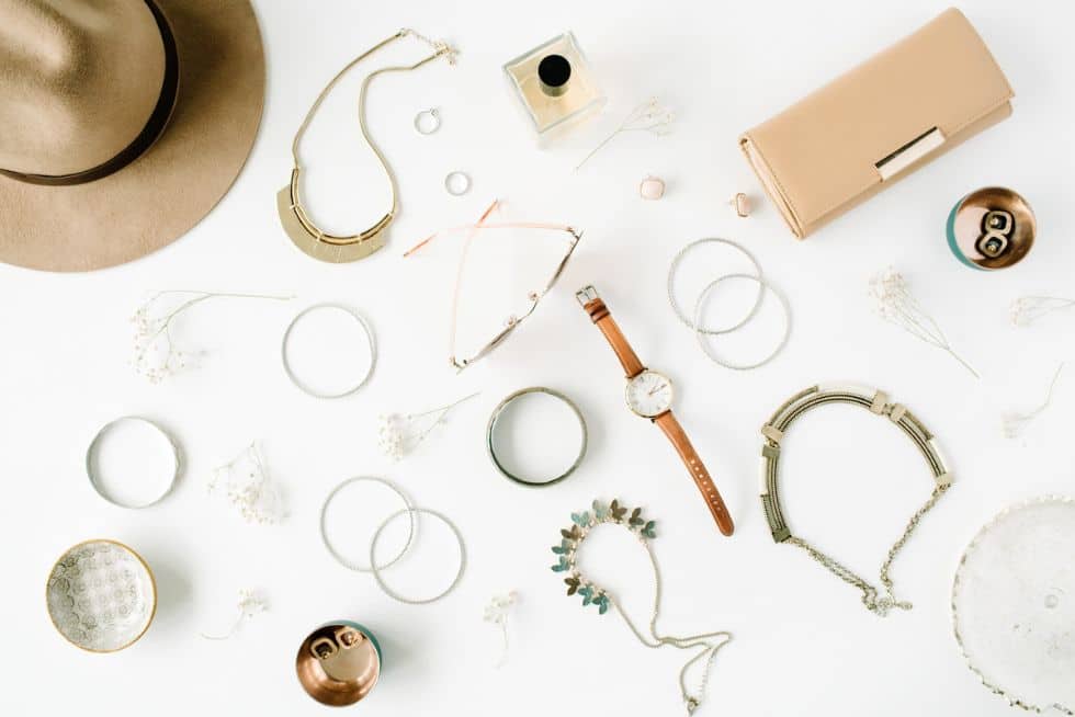 a group of jewelry and accessories on a white surface