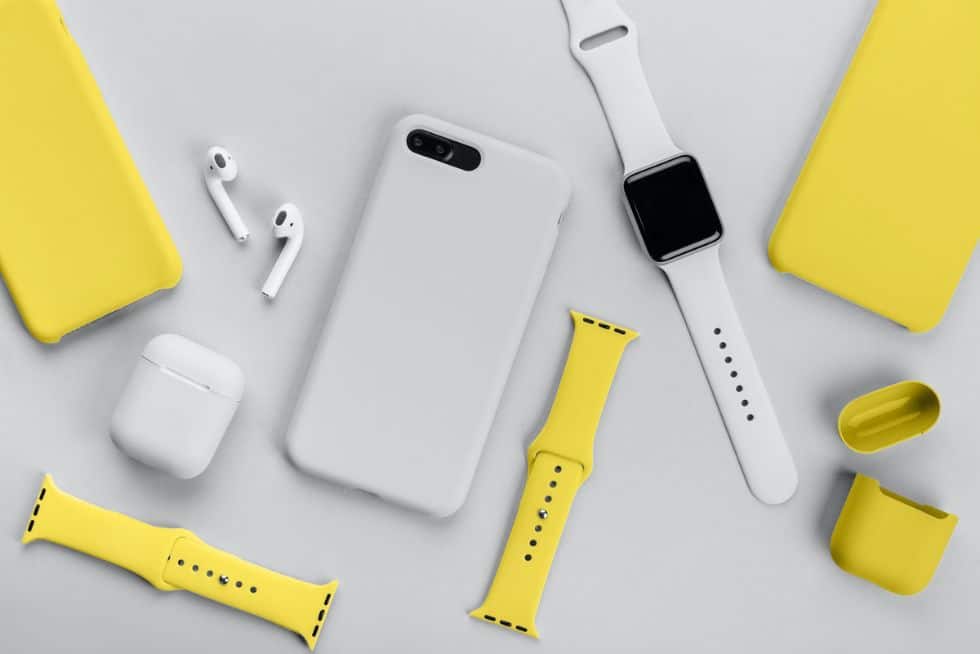 a group of white and yellow smart watches