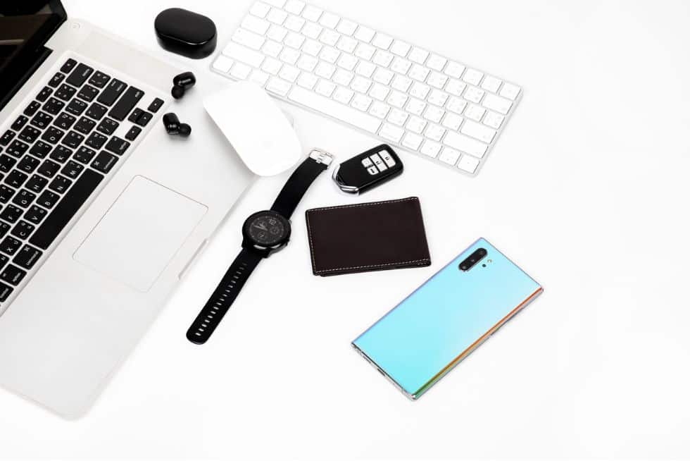 a keyboard and cellphone on a white surface